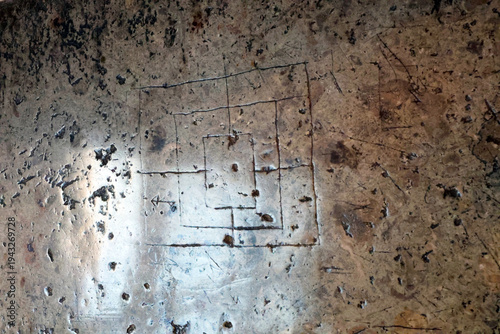 Obraz na płótnie An ancient carved board for playing mills (backgammon) or tabula lusoria variant