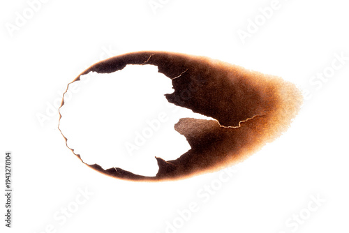 Fotografia Paper sheet with irregular burnt hole and dark scorch marks isolated on white ba