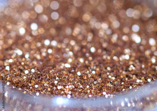 Rose Gold Glitter in Glass Container Extreme Macro Close-Up with Shallow Depth of Field Bokeh — Luxurious Metallic Shimmer Background for Beauty Fashion and Celebration