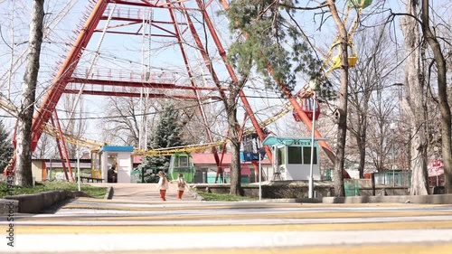 two little twin girls walking in the park in spring