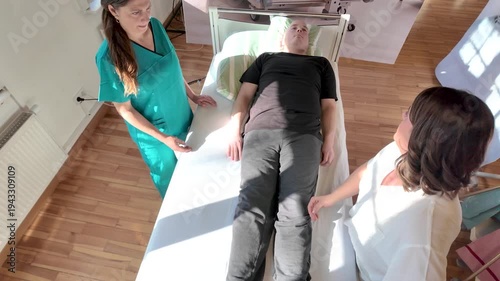 Top view of nursing instructor guiding student nurse during 30 degree positioning for pressure ulcer prevention and patient mobility