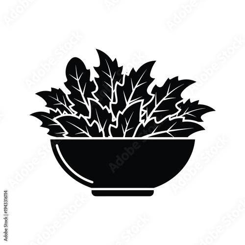 Black and white silhouette of fresh salad leaves in a bowl