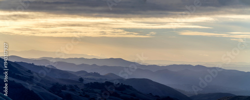 Panel kuchenny z motywem Panorama from view of valley and mountains with layers at sunrise, sunset, with clouds in sky