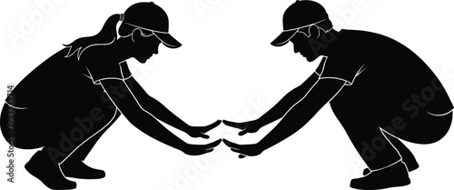 Silhouette of a man and woman squatting and reaching out to touch hands representing teamwork, partnership, cooperation, and collaborative effort.