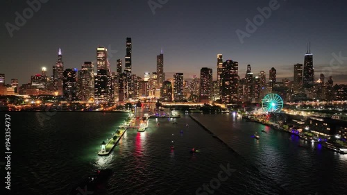  Aerial View of the Chicago Skyline at Night with Chicago River and Boats on the Water, Illuminated City Lights in Downtown Chicago, Illinois, USA