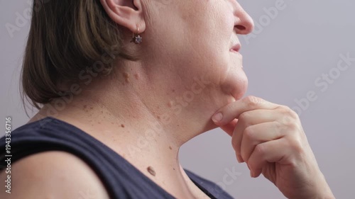 Elderly woman with double chin on isolated background