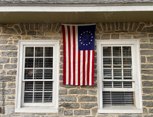 Konstfotografi Betsy Ross (13 stars) flag hanging from a historical stone building in Pennsylva