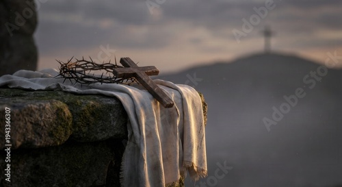 Wooden cross and crown of thorns on a white linen shroud. Religious scene on a stone tomb with Golgotha hill in the background. Christian Easter and Good Friday concept. Copy space for text