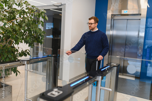 Man using key card entering secure office building