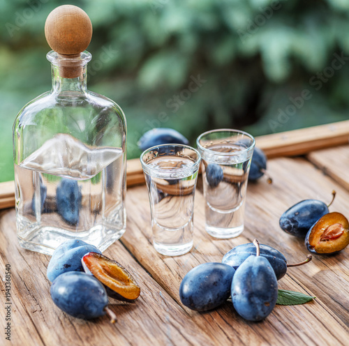 Cuadro en lienzo Slivovice, traditional Balkan plum brandy and national drink of Serbia and several Eastern European countries, still life with fresh plums