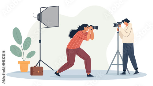 Two photographers taking pictures with professional cameras and lighting equipment in a studio setting.