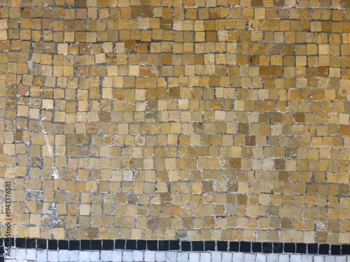 Canvas Print Uniform grid of golden aged yellow ocher tilework stone tesserae historic mosaic