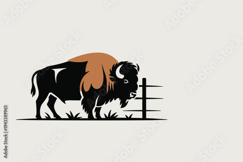 American bison silhouette standing near simple ranch fence.