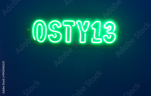 illuminated sign with the inscription OSTY 13