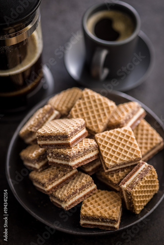 Stack of Chocolate Wafer Cookies on Plate with Coffee Cup and French Press