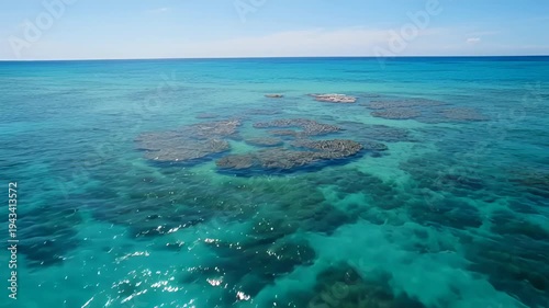 Scenic view of a vibrant turquoise ocean and coral reefs in shallow waters