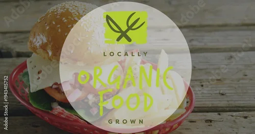 Fototapeta Showing cheeseburger in red basket on wood table, featuring fries and LOCALLY ORGANIC FOOD GROWN