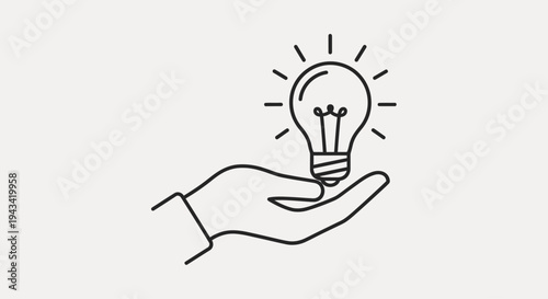 Hand holding glowing light bulb idea.