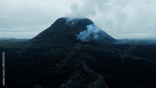 ominous volcanic landscape shows lava spewing under a cloudy sky in Iceland