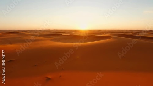Golden sunset over endless sand dunes in the arid desert landscape
