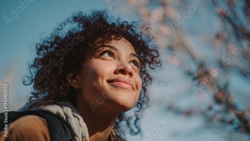 Young woman looking at sky with smile