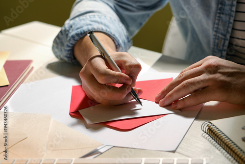 Fotografie Man writing letter at white wooden table indoors, closeup