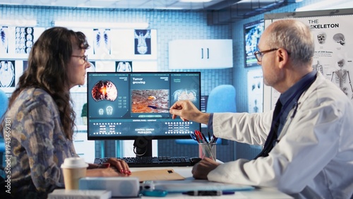 Photos Male oncology expert reviews radiography results with a patient, discussing lifestyle changes, nutrition and exercise to improve immunity and reduce cancer risk factors