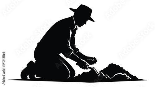 Man kneeling and digging in the dirt with a shovel