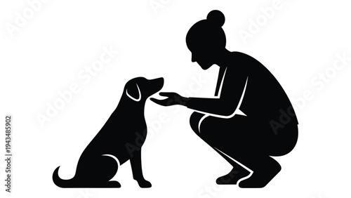 Woman giving treat to sitting dog