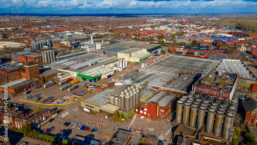 Aerial panorama of massive industrial brewery plant and parking