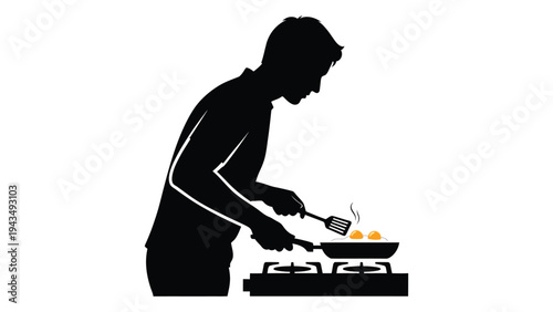 Man cooking on a gas stove with a frying pan