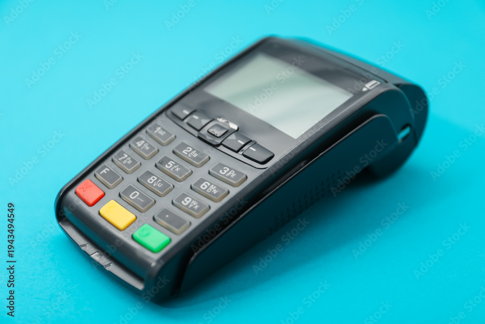 Obraz premium One payment terminal on light blue background, closeup
