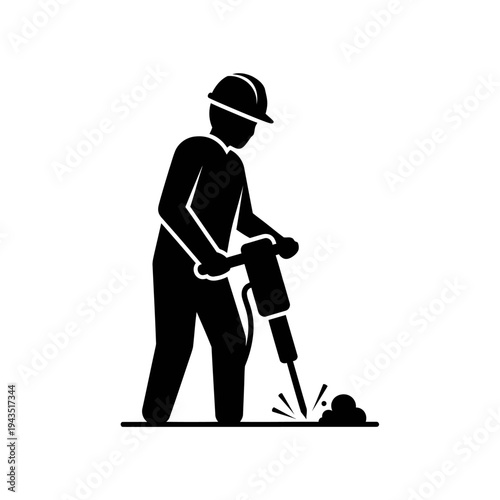 Man wearing hard hat drilling ground.