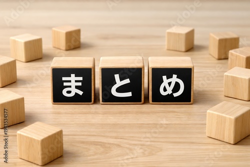 木目調のテーブルに置かれたまとめという文字入りの黒い積み木と散らばる木のブロック