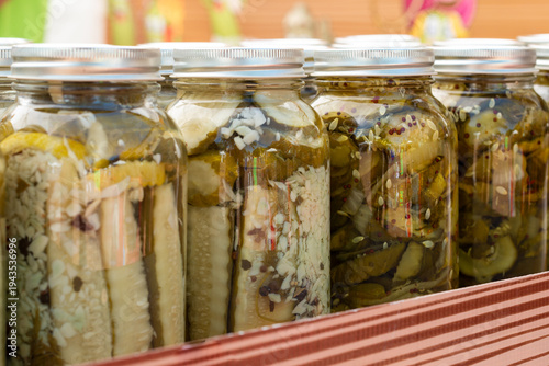 Fotografi A row of glass jars with silver lids