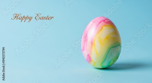 Colorful Easter egg on blue background with Happy Easter text