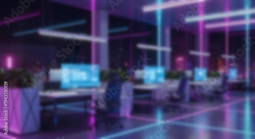 Blurred office background with neon lights and computers in a modern workspace setting