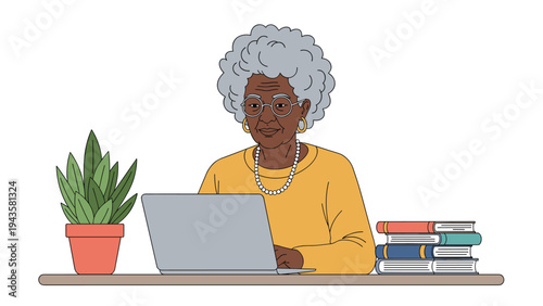Senior Black woman wearing glasses and working on her laptop at a desk with books and a green plant in a home office setting.