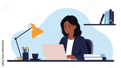 Professional Black woman sitting at a desk and working on her laptop in a bright office with books and a lamp.