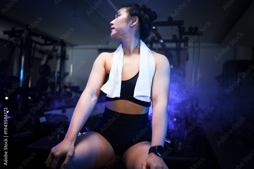 Fototapeta premium Building sustainable strength. Asian female athlete demonstrating functional back muscle power on lat machine in modern Cyberpunk wellness studio. Redefining physical limits through technology.