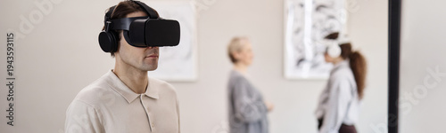 Fotografi Header of Caucasian young adult man wearing virtual reality headset standing in