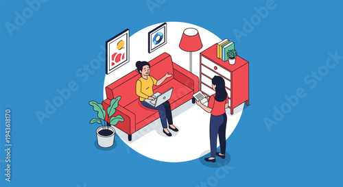 Two female colleagues discussing a project in a cozy home office setting with one woman sitting on a sofa and using a laptop computer.