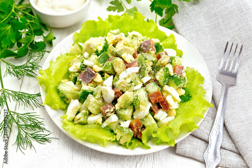 Salad of salmon and avocado on white board