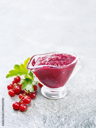 Sauce of redcurrant on stone table