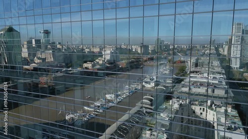 View of city buildings and marina from high-rise window on a clear day