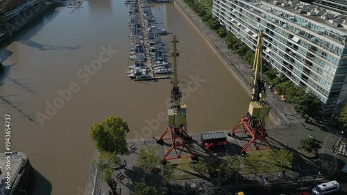 Cranes and boats at the docks near riverside in Buenos Aires during daytime
