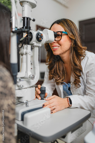 Eye doctor performing vision examination with slit lamp