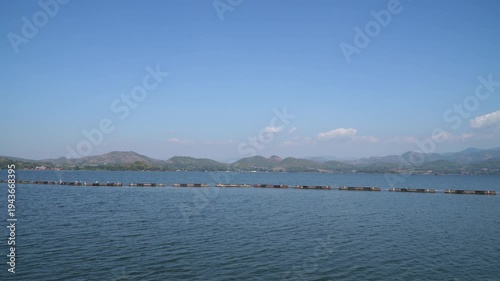 floating homestay resort with skyline reflection on lake at sunrise in Srinakarin or Srinagarind Dam
