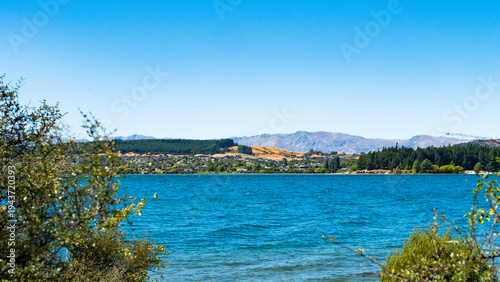 ruby island wanaka beautiful scenery landscape views lake blue water clear blue sky mountains trees lush green stunning iconic new zealand