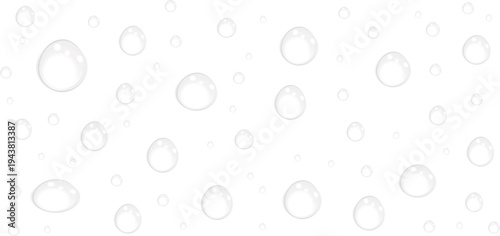 A grayscale image of scattered raindrops on a transparent surface